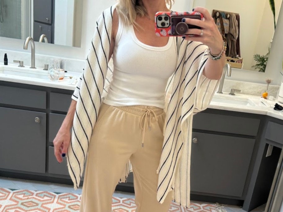 woman taking selfie in bathroom mirror
