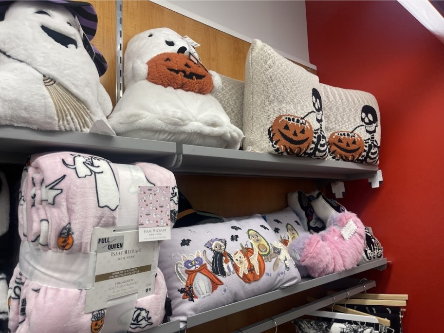 various halloween throw pillows on a store shelf