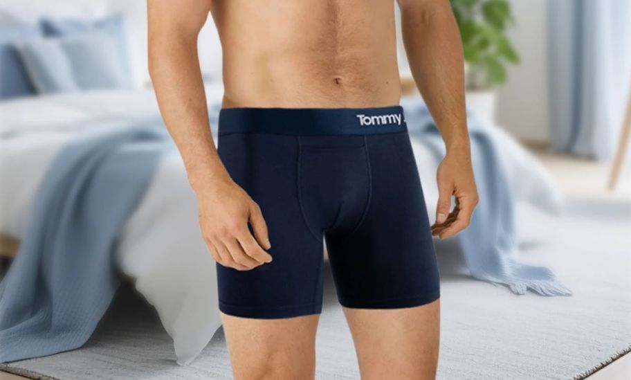 a man in a pair of navy blue boxer briefs