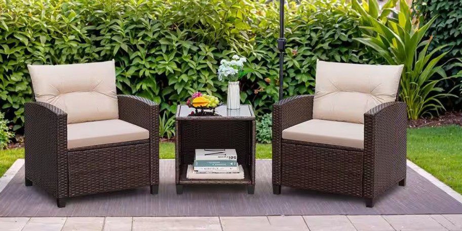 brown wicker patio set with white cushions with matching table