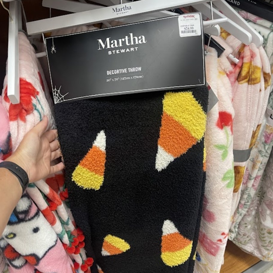 a black halloween throw in candy corn print
