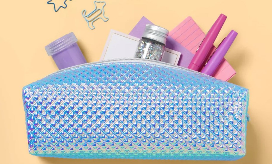 school supplies coming out from a textured iridescent pencil case