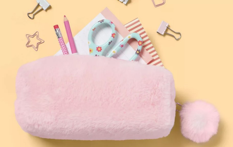 school supplies coming out from a fuzzy pink pencil case