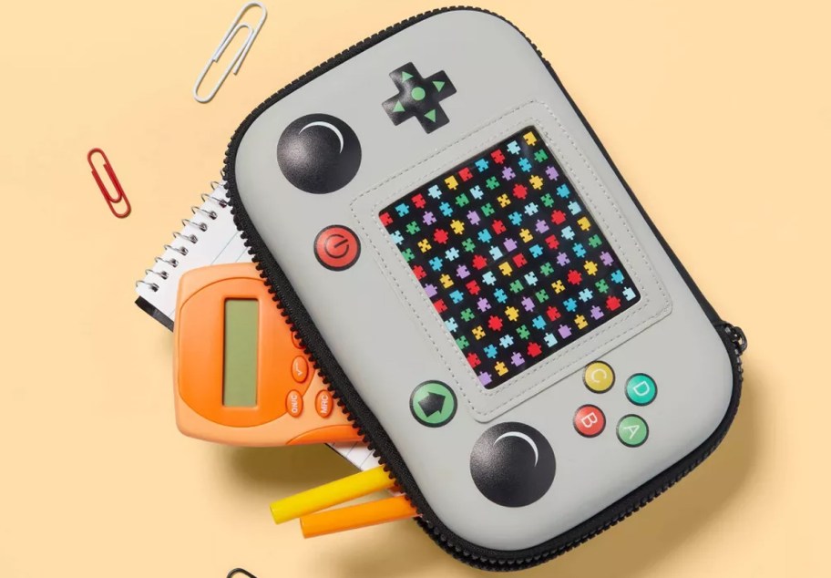 grey and black video game controller shaped pencil case