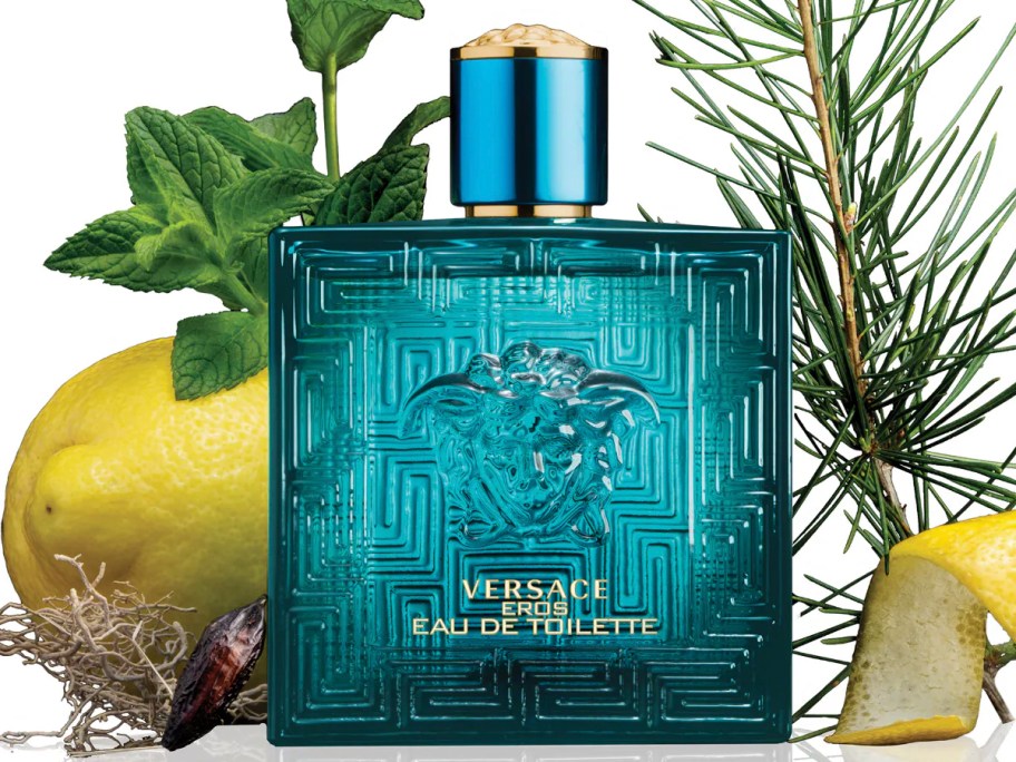 blue bottle of versace with fruit and plants 