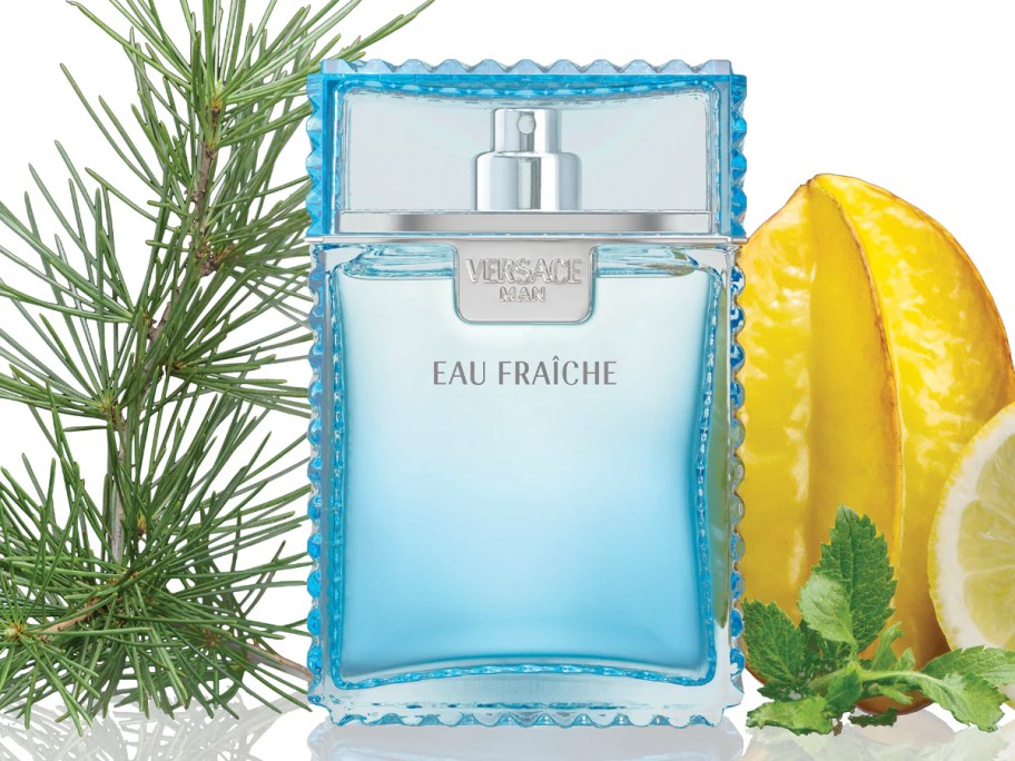 bottle of versace cologne with fruit and plants 