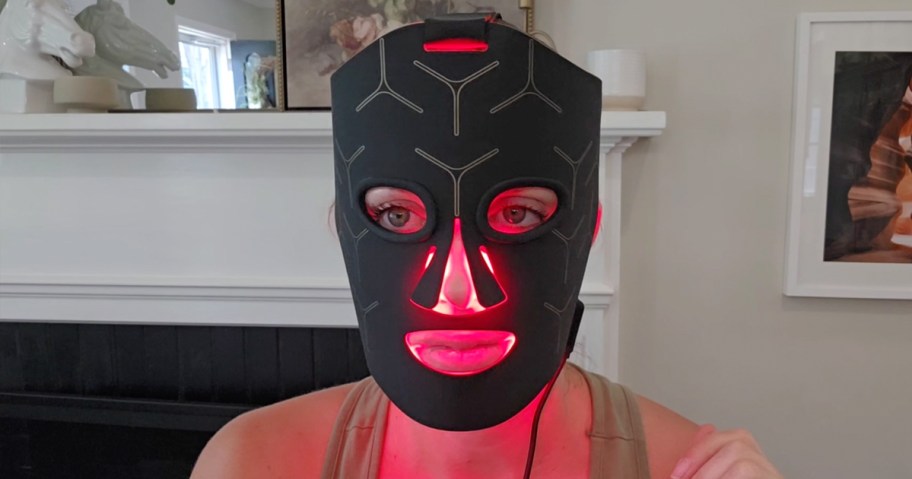 woman wearing red light therapy mask