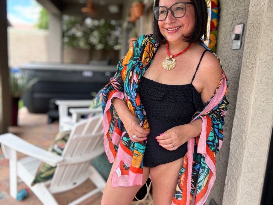 woman in black bathing suit and colorful cover up