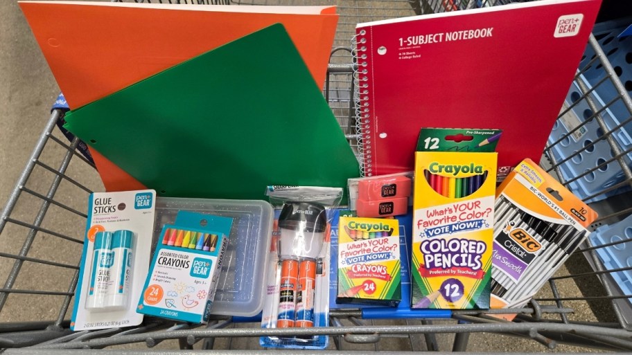 a walmart cart filled with various school supplies