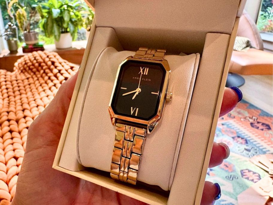 hand holding amazon women's gold watch 