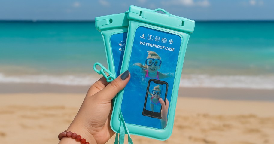 person holding waterproof phone pouches at the beach