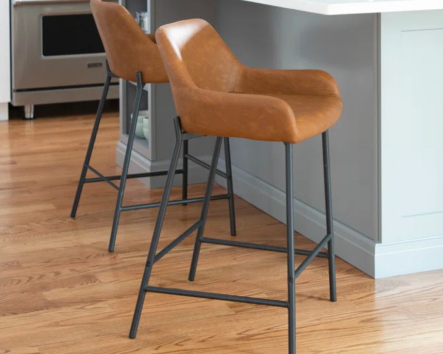 brown upholstered counter stools on black frame