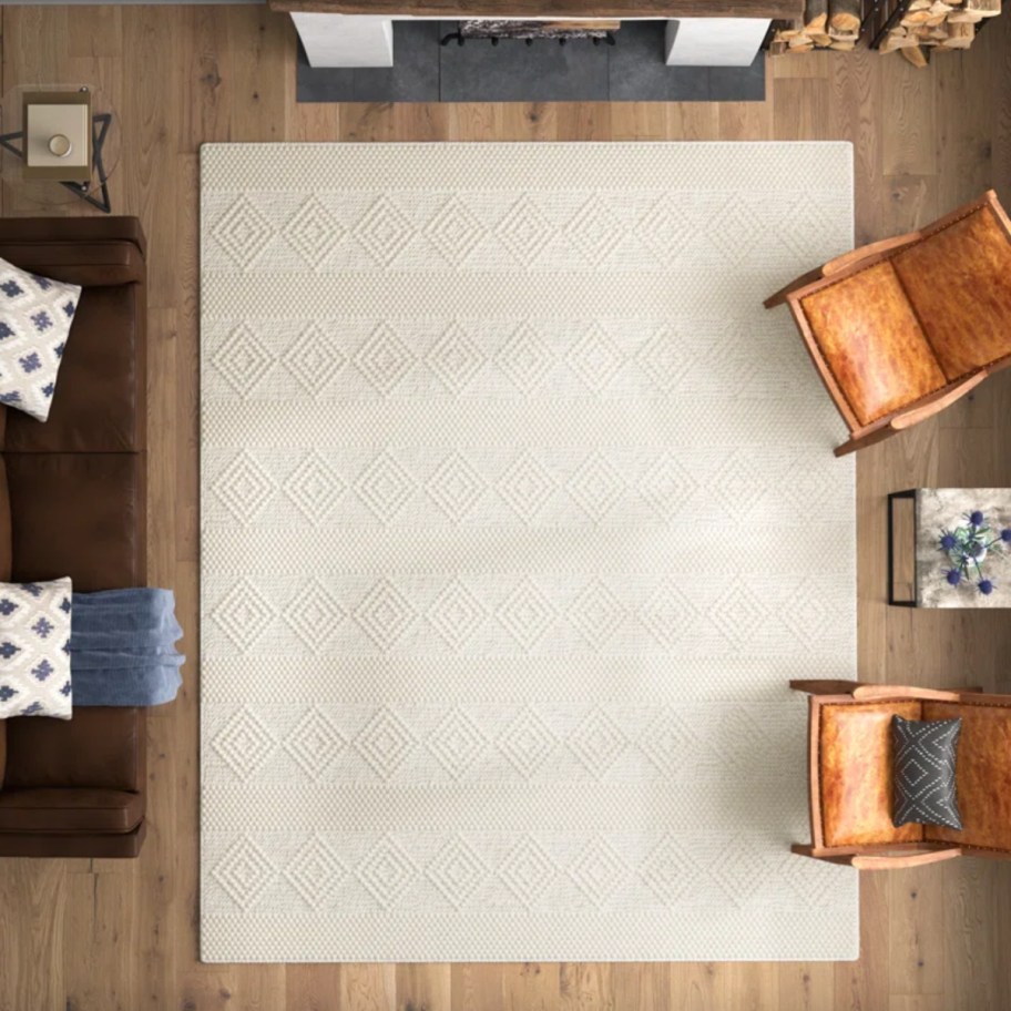 8 x 10 beige diamond area rug surrounded by chairs
