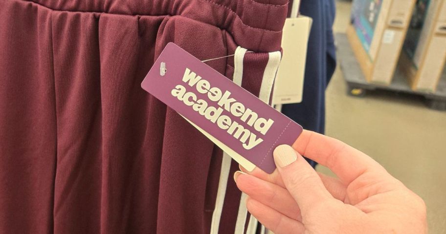 hand holding weekend academy tag in store