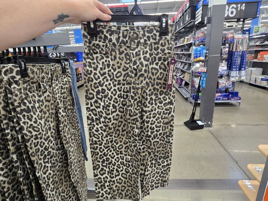 hand holding leopard print Weekend Academy Girls Baggy Straight Jeans in store