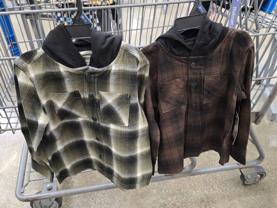 two plaid Weekend Academy Boys Hooded Flannel Shackets hanging on cart in store