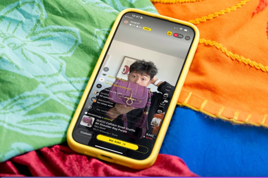 whatnot livestream on phone on pile of colorful sheets