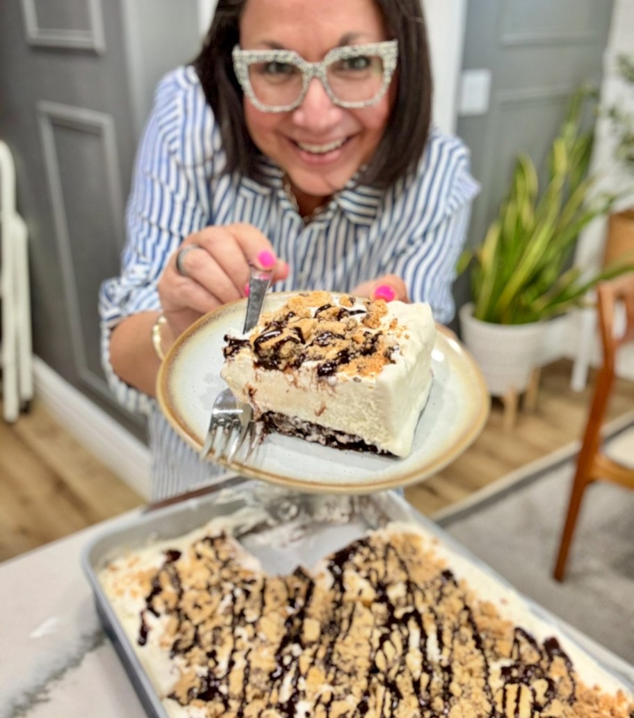 woman holding a slice of brownie ice cream cake 