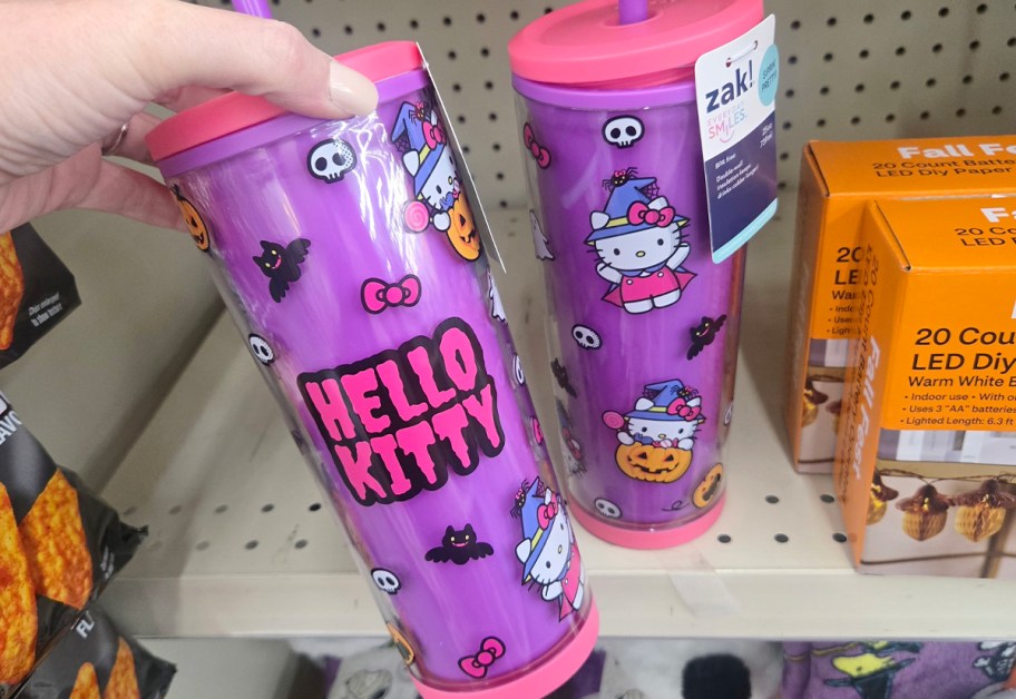 hand reaching for purple hello kitty halloween tumbler